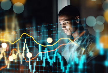 A desktop monitor screen showing technical market trading graphs